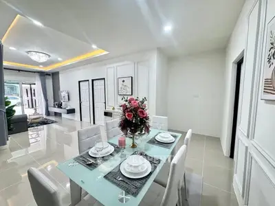 Modern open-plan dining and living area with elegant decor and natural light.