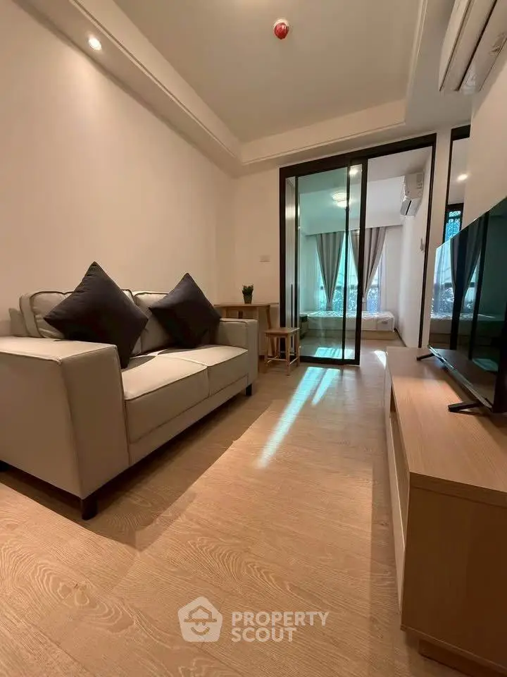 Modern living room with sleek design and cozy ambiance in a stylish apartment.