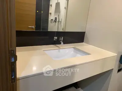 Modern bathroom with sleek sink and large mirror