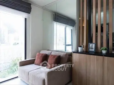 Modern living room with cozy sofa and large windows for natural light