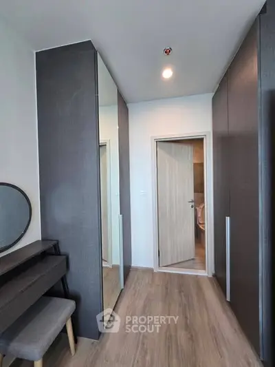 Modern bedroom with sleek wardrobe and vanity in a stylish apartment