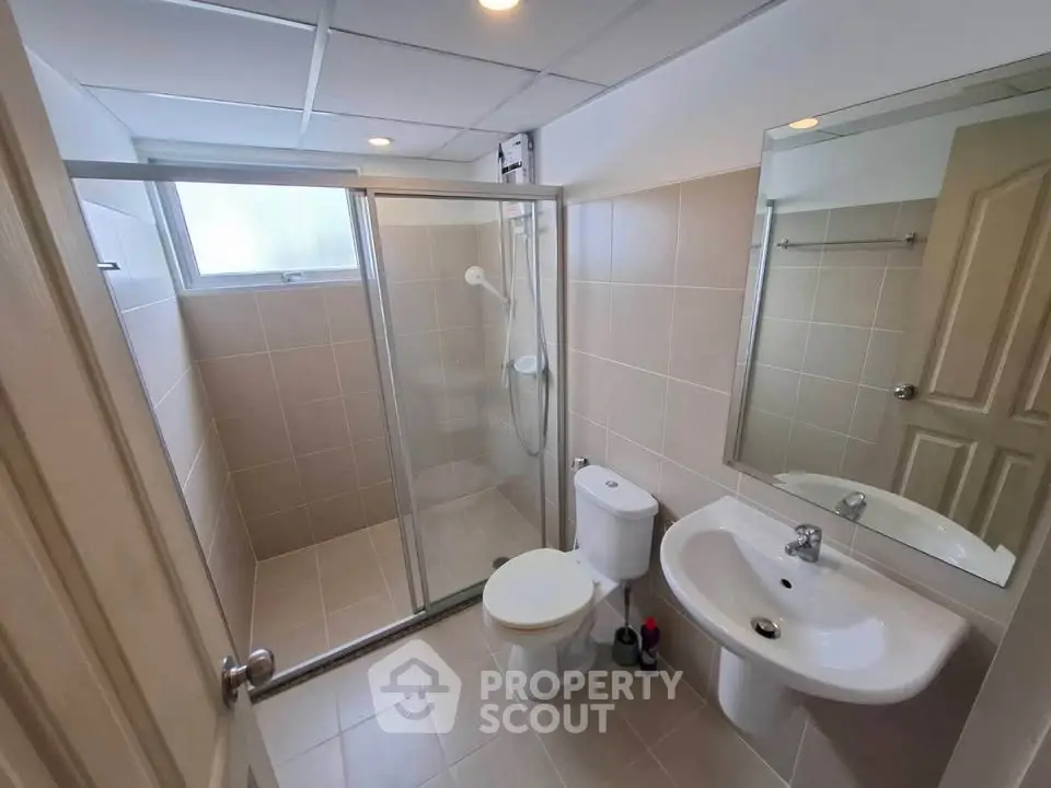 Modern bathroom with glass shower enclosure and sleek fixtures