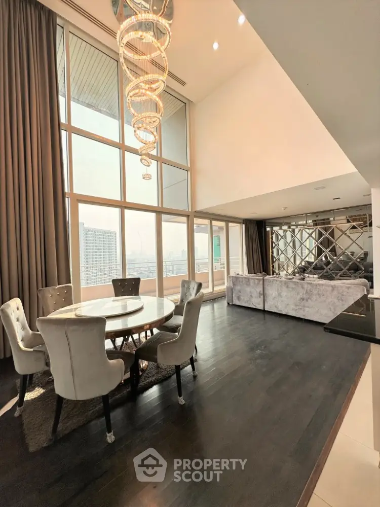 Luxurious high-rise living room with floor-to-ceiling windows and elegant chandelier
