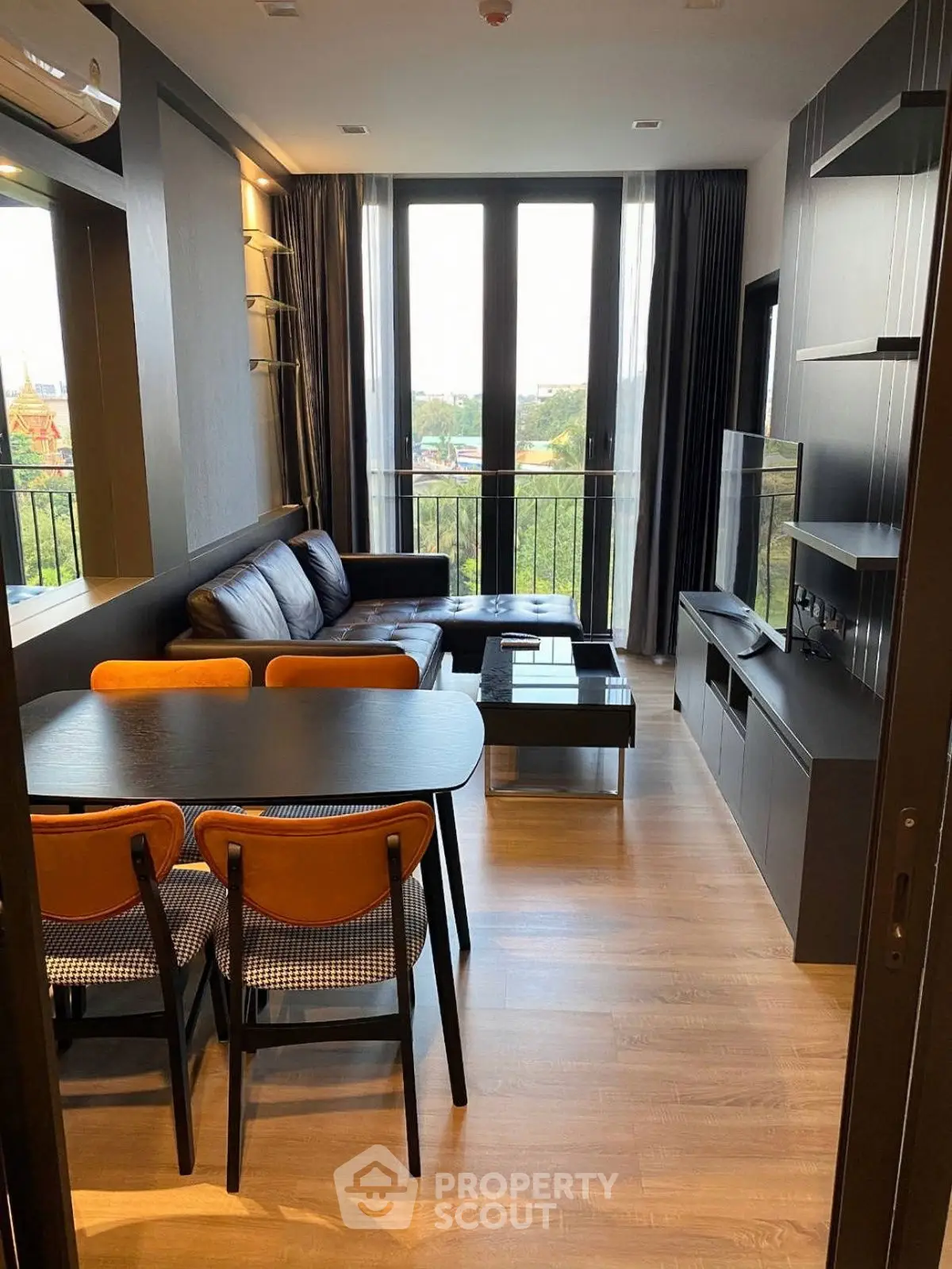 Modern living room with large windows and stylish furniture, offering a cozy and inviting atmosphere.