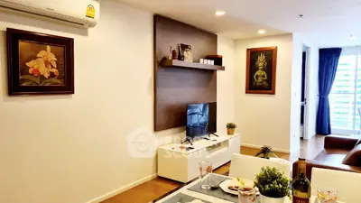 Modern living room with stylish decor and natural light, perfect for relaxation.