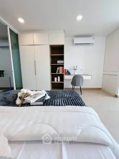 Modern bedroom with sleek built-in storage and cozy decor