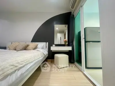 Modern bedroom with stylish decor and sliding glass door to balcony