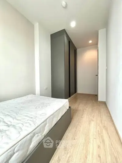 Modern minimalist bedroom with sleek wardrobe and natural light