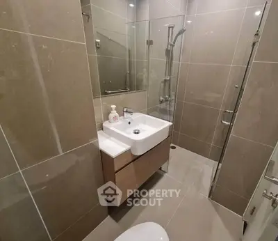 Modern compact bathroom with sleek design and glass shower enclosure