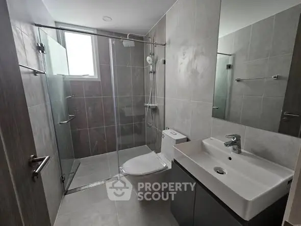 Modern bathroom with sleek fixtures and glass shower enclosure