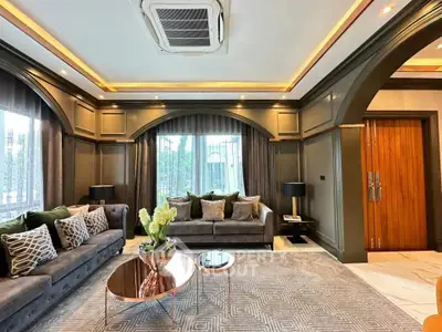 Luxurious living room with elegant decor and large windows, featuring plush sofas and stylish lighting.