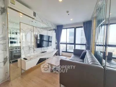Luxurious modern living room with marble accents and large windows offering stunning city views.