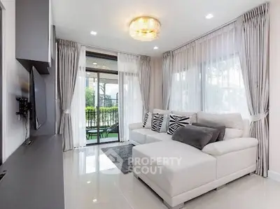 Modern living room with elegant decor and large windows
