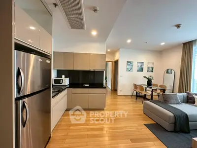 Modern open-plan kitchen and living room with sleek appliances and stylish decor
