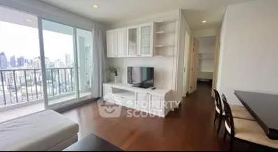 Spacious living room with city view and elegant wooden flooring