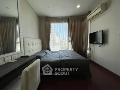 Modern bedroom with city view, featuring sleek furniture and natural light.