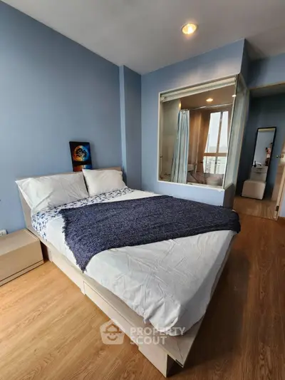 Cozy bedroom with modern decor and large window for natural light