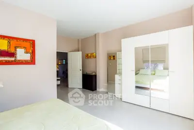 Spacious bedroom with modern decor and ample natural light