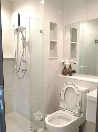 Modern bathroom with shower and sleek fixtures in a contemporary home.