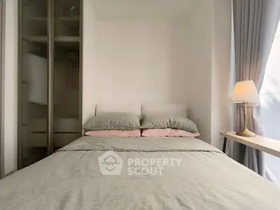 Cozy bedroom with modern decor and soft lighting, perfect for relaxation.