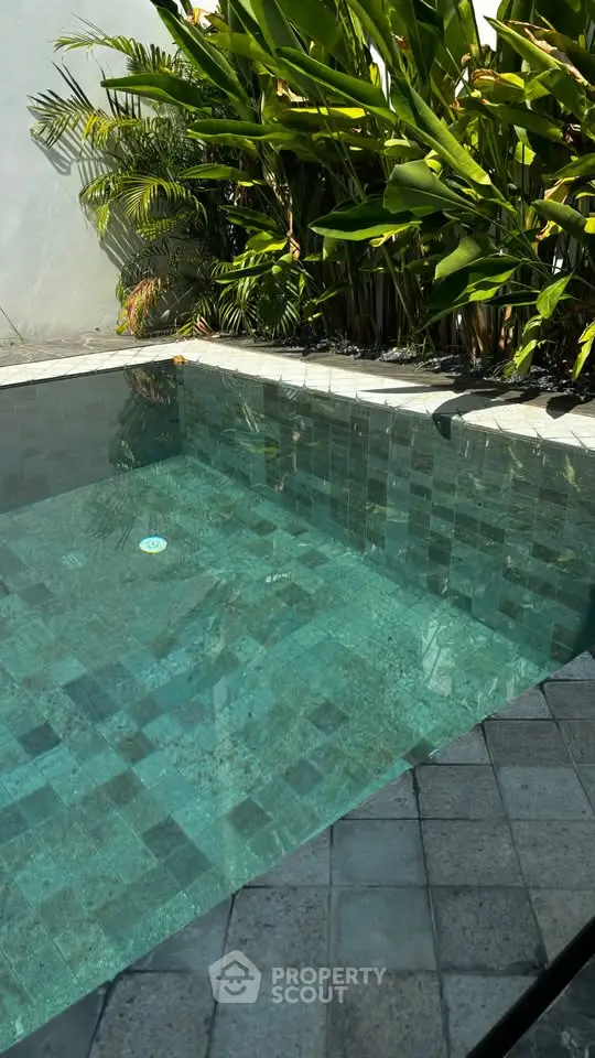 Luxurious private pool with lush greenery, perfect for relaxation and leisure in a serene setting.