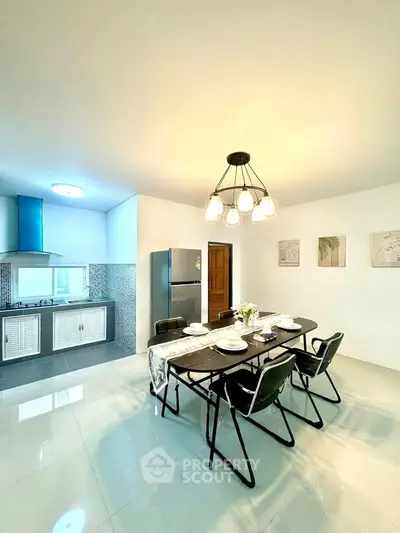Modern kitchen and dining area with sleek design and stylish lighting