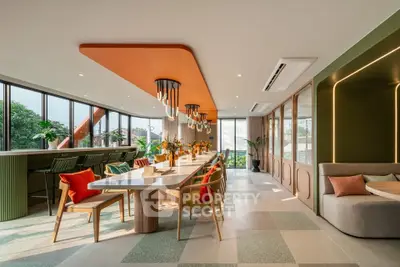Spacious modern dining area with vibrant decor and large windows offering lush garden views.