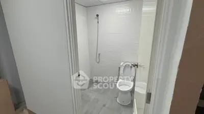 Modern minimalist bathroom with white tiles and sleek fixtures