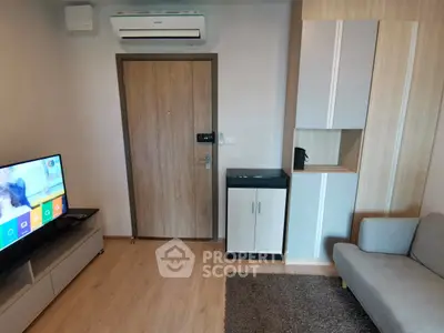 Modern living room with sleek furniture and wall-mounted air conditioner, perfect for cozy urban living.