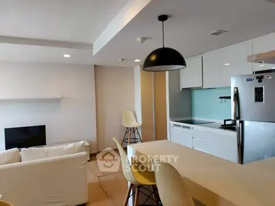 Modern open-layout living room and kitchen with sleek design and stylish furniture