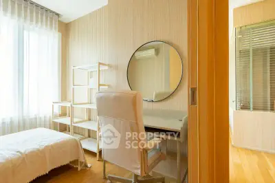 Bright and cozy bedroom with modern desk and chair, perfect for a home office setup.