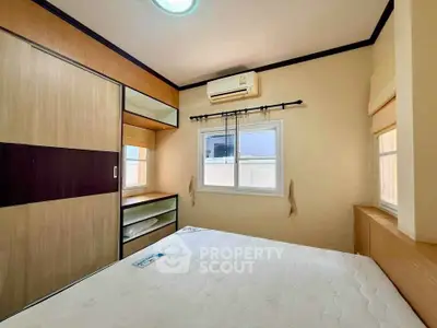 Cozy bedroom with built-in wardrobe and air conditioning, perfect for restful nights.