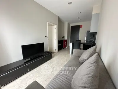 Modern living room with sleek furniture and open kitchen layout