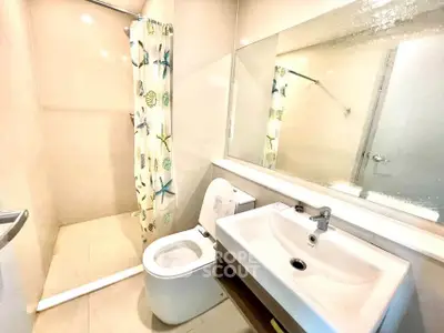 Modern bathroom with sleek fixtures and stylish shower curtain in a bright, contemporary design.