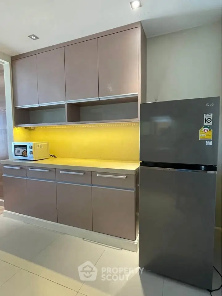 Modern kitchen with sleek cabinets and stainless steel fridge