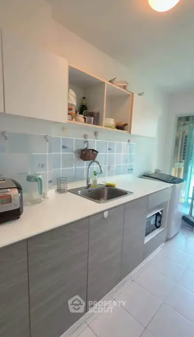Modern kitchen with sleek cabinets and appliances, featuring a bright and airy design.