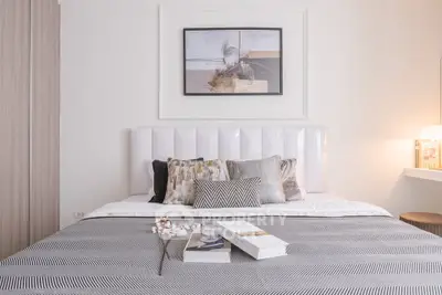 Elegant bedroom with stylish decor and cozy bedding in modern apartment.