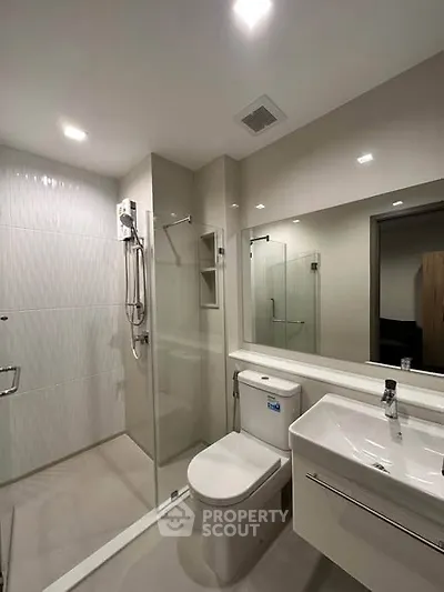 Modern bathroom with glass shower and sleek fixtures