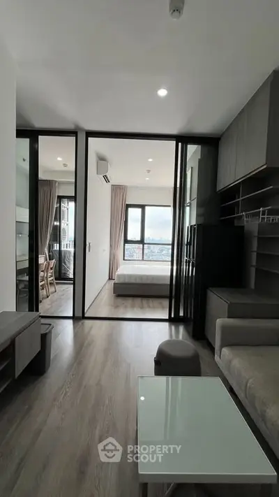 Modern apartment interior with open layout and large windows offering city view