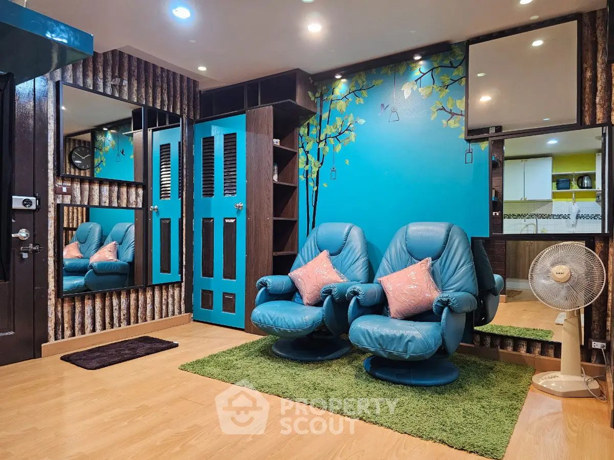 Cozy living room with blue recliners and vibrant wall art