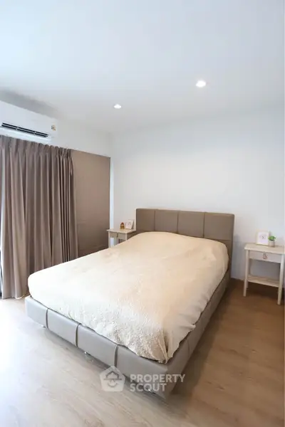 Modern bedroom with cozy bed and natural light in stylish apartment
