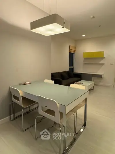 Modern dining area with sleek furniture and ambient lighting in a stylish apartment.