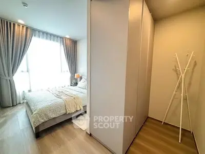 Cozy bedroom with elegant decor and natural light, perfect for relaxation.