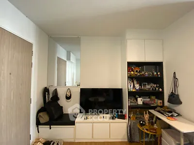 Cozy living room with modern TV setup and ample storage space