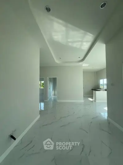 Spacious modern living room with elegant marble flooring and high ceiling