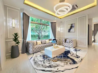 Luxurious living room with elegant decor, plush seating, and large window with garden view.