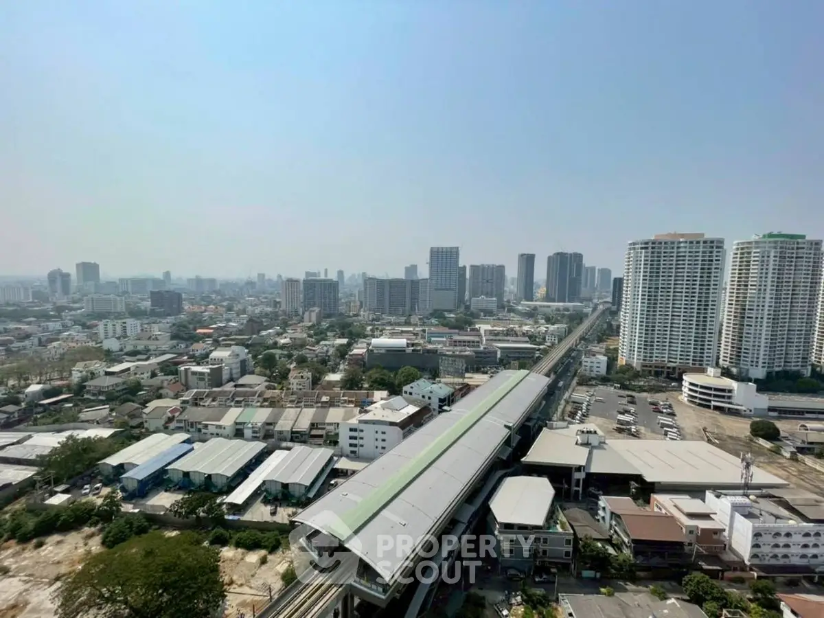 Stunning cityscape view from high-rise building showcasing urban skyline and transportation hub.