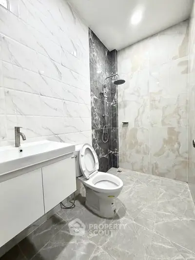 Modern bathroom with sleek marble tiles and contemporary fixtures