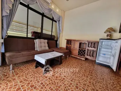 Cozy living room with brown sofa, open mini fridge, and stylish tiled floor.