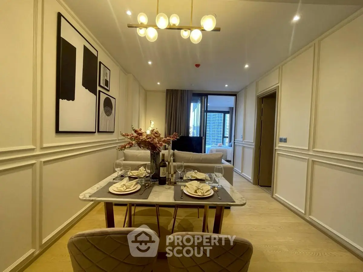 Elegant dining area with modern decor and open view to living room in luxury apartment.